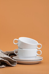 Set of stylish ceramic tableware on colour background