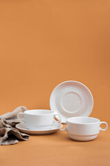 Set of stylish ceramic tableware on colour background