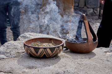 offering coca leaf, payment to Pachamama in Argentina. Ritual with incense