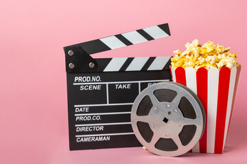 Tasty popcorn in buckets and cold cola drinks with cinema tickets, movie clapper and 3D eyeglasses...