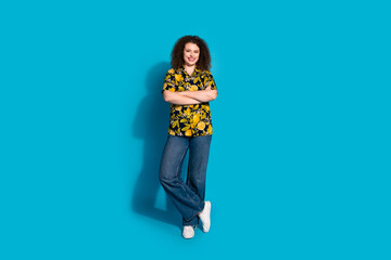 Full length photo of adorable lovely girl wear print shirt arms crossed empty space isolated blue color background