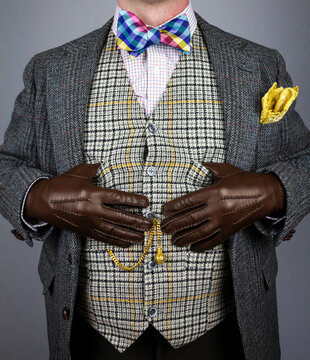 Elegant Wealthy Gentleman in Tweed Suit and Leather Gloves Standing Pompously. Vintage Style and Retro Fashion of Eccentric English Gentleman.
