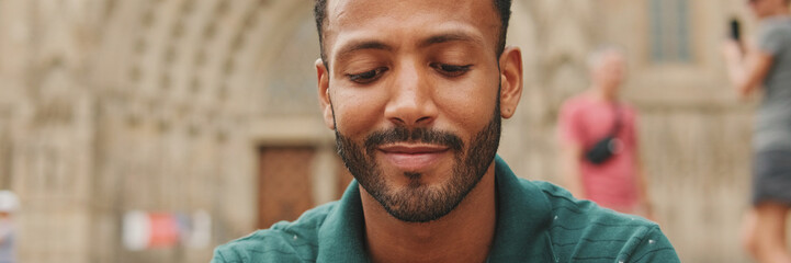 Obraz premium Close up, young man sitting on the steps of the Sagrada Familia in Barcelona