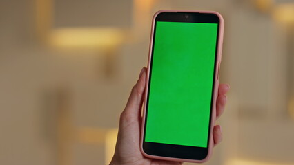 Businesswoman hand swiping chroma key mobile phone at workplace close up. 