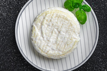 soft cheese cow milk, goat or sheep cheese natural fresh appetizer meal food snack on the table...