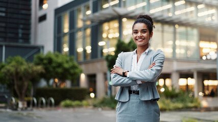 Businesswoman, arms crossed or portrait by office building in city for career, smile for accounting. Female accountant, professional employee or confidence for finance job in urban with corporate