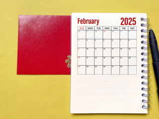 February 2025 monthly calendar with red envelope background. Stock photo.