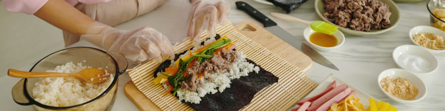 Header with housewife preparing korean kimbap at home