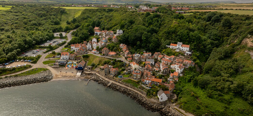 Runswick Bay Aerial View. Runswick Bay is a picture postcard North Yorkshire coastal village, boasting a mile of secluded bay and gorgeous beach. Situated nine miles north of Whitby.
