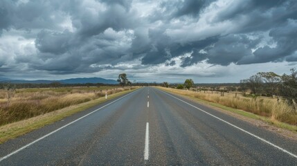 Straight road on Matilda Highway under overcast skies in Queensland