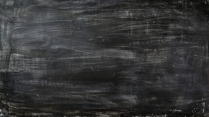 Obraz premium This image features a dark chalkboard, extensively marked with white chalk, depicting the remnants of previous writings and erasures commonly seen in classrooms.