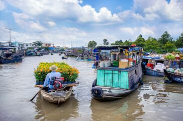 View of Nga Nam floating market with scenes of buying and selling goods on boats. This market is located at the intersection of five rivers in Soc Trang province of Mekong delta, Vietnam.