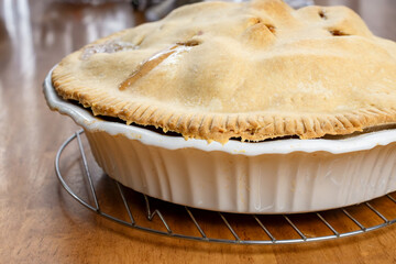 Making a pie:  Completed pie on the wooden table.