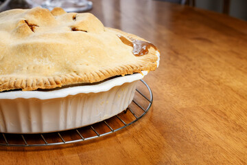 Making a pie:  Completed pie on the wooden table.