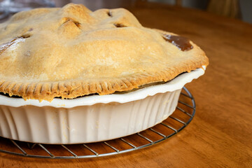 Making a pie:  Completed pie on the wooden table.