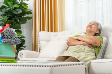 Senior woman resting at home, woman relax fall asleep on comfortable couch in living room