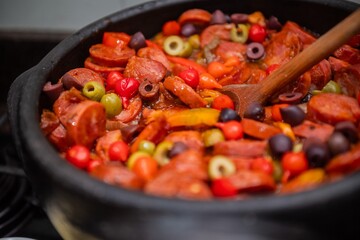 Typical brazilian cuisine, specially from Minas Gerais State, made of beans, sausage, pepper and olive.