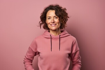 Fototapeta premium Portrait of a satisfied woman in her 40s wearing a thermal fleece pullover while standing against solid color backdrop