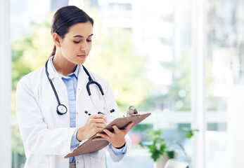 Woman, doctor and writing with clipboard for medical study, diagnosis or research at hospital. Female person or healthcare employee taking notes for discovery, information or prescription at clinic