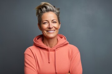 Obraz premium Portrait of a satisfied woman in her 40s wearing a thermal fleece pullover isolated in solid color backdrop