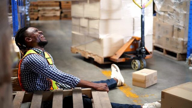 4K Video slow motion of an accident where a black male employee was crushed by a pallet and injured while working in a warehouse. unsafe work practices, Workplace safety concept
