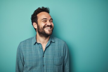 Obraz premium Portrait of a joyful man in his 30s dressed in a relaxed flannel shirt isolated in solid pastel color wall