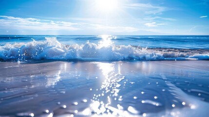 Sunlight reflecting on gentle ocean waves with clear blue sky