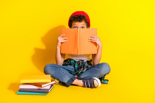 Full size photo of small charming boy read book cover face wear trendy white outfit isolated on yellow color background