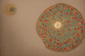 Tajikistan suzani embroidery inspired floral and sun motif wallpaper