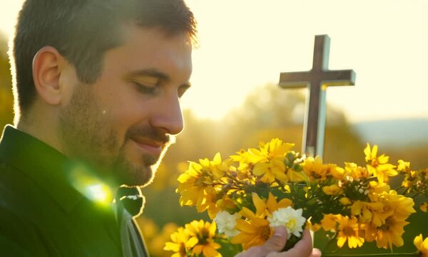 On a warm spring day with strong sunlight, he is holding yellow forsythia flowers and buds and the Holy Cross of Jesus Christ in his hand