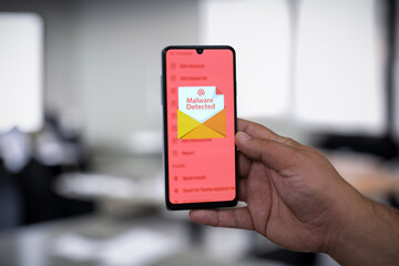 Smartphone Screen Displaying 'Malware Detected' Warning Message - Cybersecurity Alert Concept