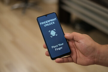 Biometric Identification. Men Unlocking Smartphone Scanning Fingerprint With Personal Verification App At Workplace Indoor, Top View. Phone Authorization Concept