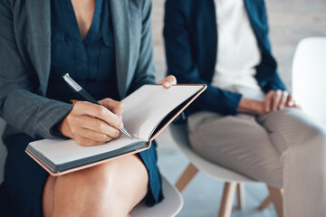 Woman, notebook and writing at job interview for notes, waiting room and candidates for opportunity. Female person, schedule and diary for appointments, company and planning in journal with coworkers