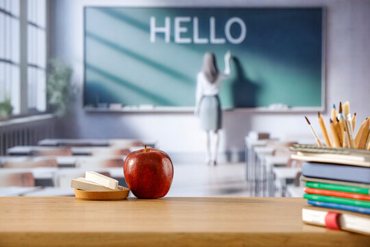 Wooden desk with copy space with blurred school classroom background. Copy space for products. Educational concept.