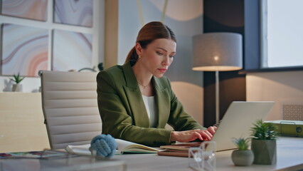 Serious lady working office typing laptop cabinet closeup. Woman texting emails