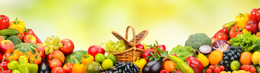 Collection bright berries, fruits and vegetables on green background.