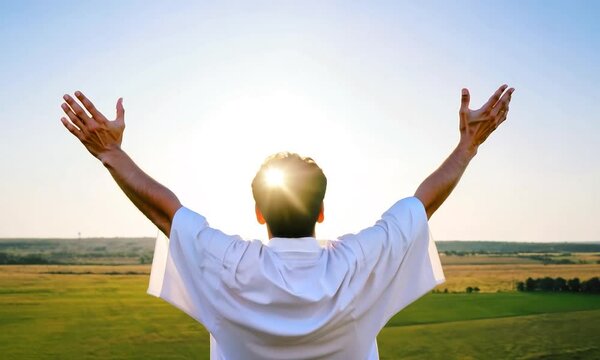 Jesus Christ with open arms reaching out in the sky, hand gestures of Jesus dying on the cross and resurrected.