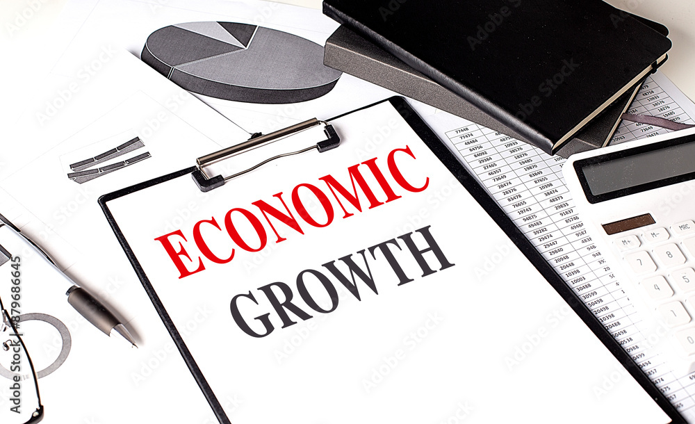 Poster economic growth text on clipboard on chart with notebook and calculator
