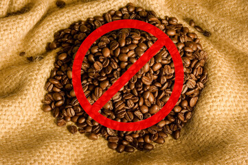 Coffee beans on canvas with warning crossed out sign. Concept of coffee risk