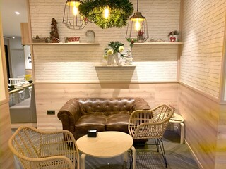 Interior of light living room with brown sofa, coffee table