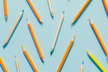 A blue background with a bunch of pencils of different colors. The pencils are arranged in a pattern, with some overlapping and others standing alone. Concept of creativity and organization