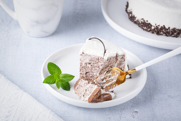 Chocolate cream cake on a white plate