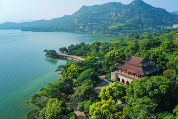 Fototapeta premium An aerial view of a beautiful Chinese garden with a lake, trees, and a pavilion.