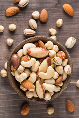 Healthy mix nuts on wooden background. Almonds, hazelnuts, cashews, peanuts, pistachios, Brazil nuts