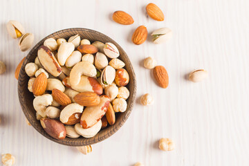 Healthy mix nuts on wooden background. Almonds, hazelnuts, cashews, peanuts, pistachios, Brazil nuts