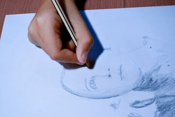 hand drawing with a pencil on paper a sketch of a woman's face