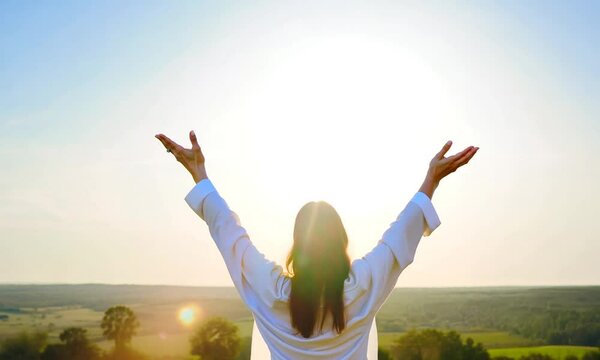 Jesus Christ with open arms reaching out in the sky, hand gestures of Jesus dying on the cross and resurrected, heaven and salvation, faith and love