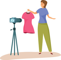 Young woman is presenting new dress recording video blog using camera on tripod