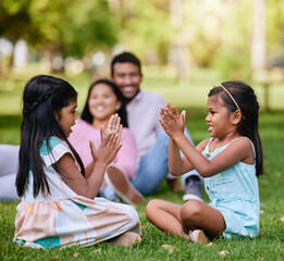 Family, play and children in nature park, siblings and traditional or hand games on grass on summer break. Parents, relaxing and girls for child development, bonding and fun activity with people