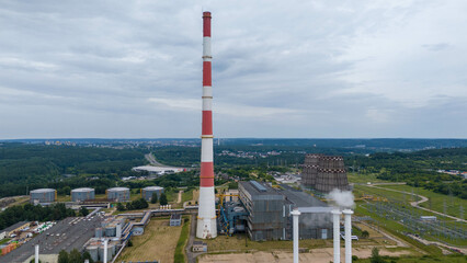 Drone photography of biomass power plant in city suburbs during summer day